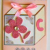 Baby's Toy Cube Card - glue rhinestone to center of flower and add a strip of washi tape to the top and trim ends