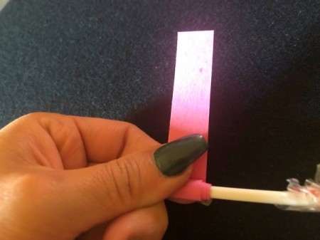 DIY Lollipop Paper Quilling Tool - use other hand to firmly wrap paper around the stick