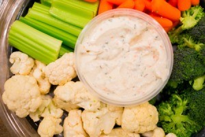 Bowl of ranch dip surrounded by the vegetables