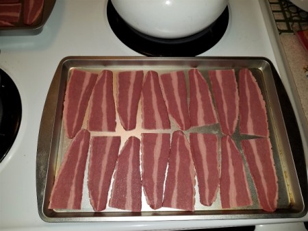 Slices of turkey bacon in a baking pan.