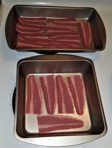 Slices of turkey bacon in baking pans.