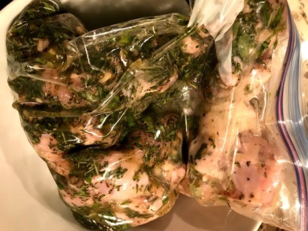 chicken and herbs in bag