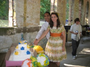 A wedding cake decorated in yellow and blue flowers.