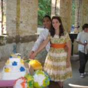 A wedding cake decorated in yellow and blue flowers.