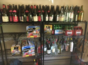 Giving Away Empty Wine and Beer Bottles - bottles on metal shelves