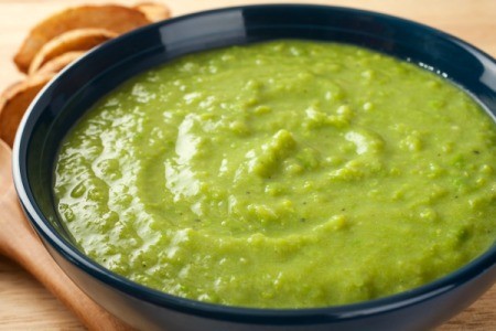 Pea soup in a black bowl