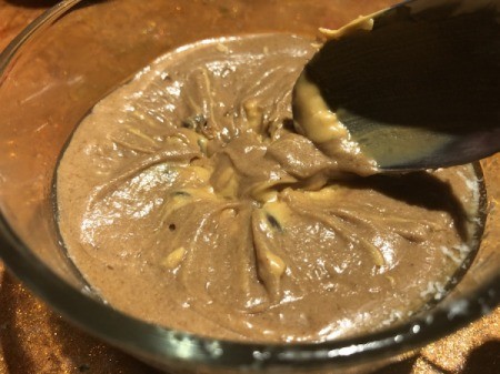 mixing batter over peanut butter mixture