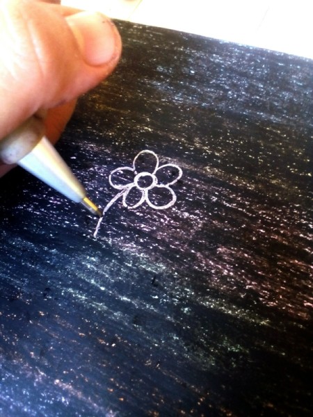 Crayon Etching - using a pointy tool start drawing through the black crayon