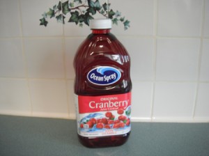 A full cranberry juice container.