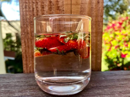 Strawberry scraps being used to make infused water.