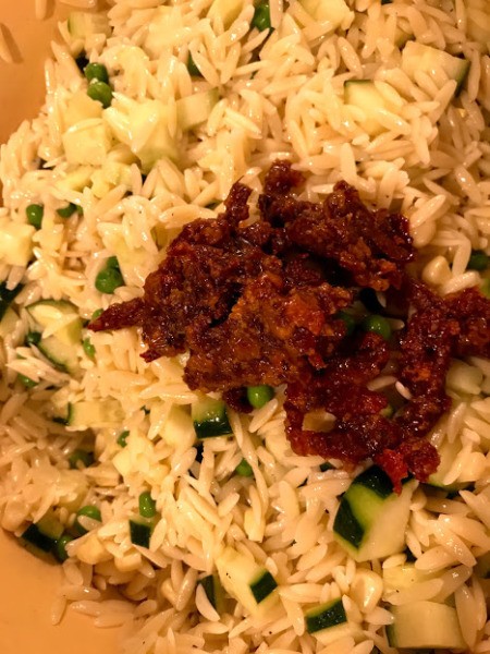 adding sun dried tomatoes to Pasta Salad