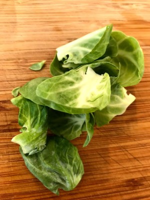 Stray leaves from Brussels sprouts that have been cut in half.
