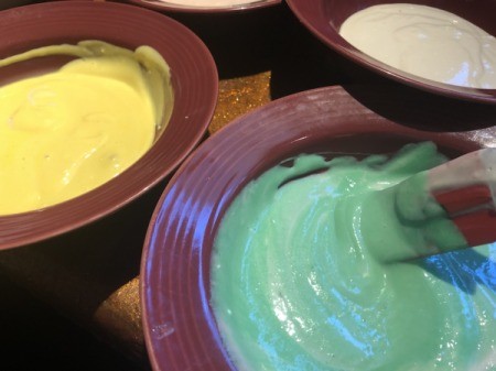 adding food coloring to bowls