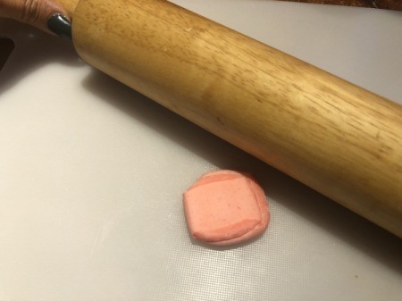 How to Make Sushi Cakes - flattening a Starburst pink candy to make a piece of fish