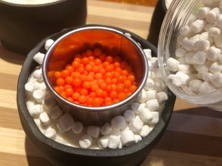 How to Make Sushi Cakes - add marshmallow bits for the rice and press down, remove the cutter