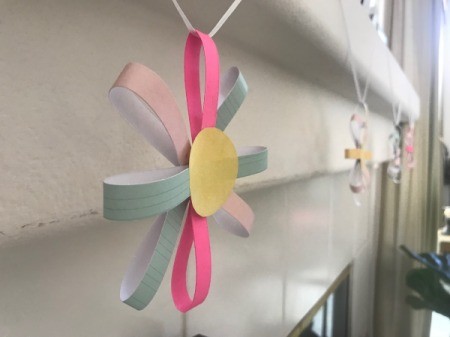 Paper Floral Garland - closeup of flower hanging on mantle from the side