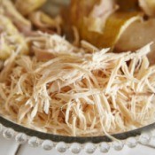 Shredded Chicken with chicken breasts on a glass plate