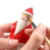 Hand painting a Santa figurine