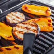 Eggplant and yellow peppers on a electric grill.