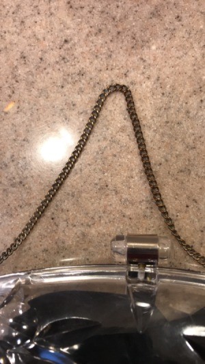 A tarnished chain that has been cleaned on the left hand side.