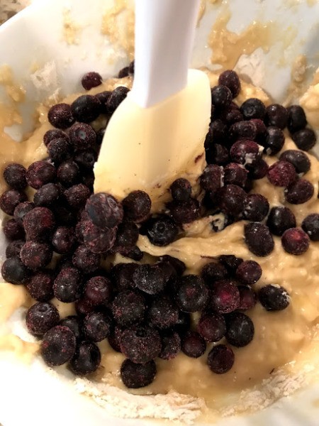 adding blueberries to batter