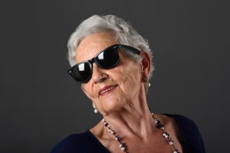 Woman with grey hair wearing sunglasses