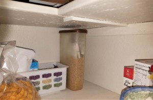 A container of boxed macaroni and cheese ingredients in the pantry.