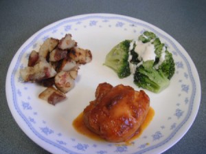 Barbecued Chicken on plate with potatoes and broccoli