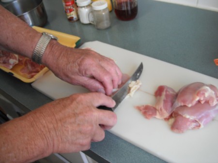 trimming fat from chicken pieces