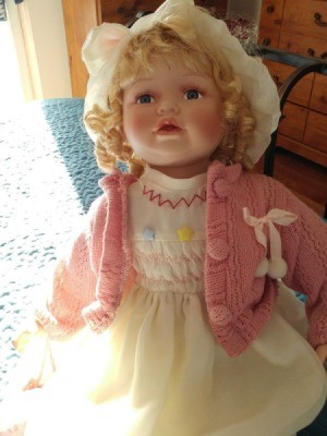 Maker and Value of a Porcelain Doll - blond doll wearing a pink sweater