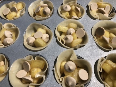 Caramel chips added to apples in tins