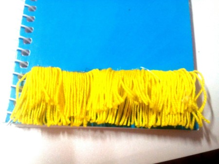 DIY Fur Covered Notebook - cut the yarn along the bottom and remove the ruller