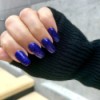 A hand with blue glittery nail polish.