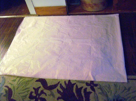 Make Big Showy Flowers from Plastic Tablecloths - lay tablecloth out flat and fold in half