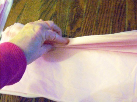 Make Big Showy Flowers from Plastic Tablecloths - accordion fold the squares of vinyl