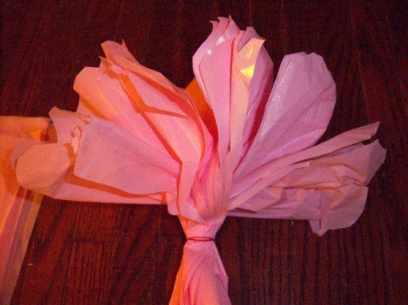 Make Big Showy Flowers from Plastic Tablecloths - pull and even bunch up the petals for uniqueness