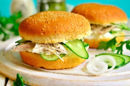Hot Chicken Sandwich with sliced cucumber and onion