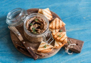 Vegetarian Paté with toasted pieces of bread on a wooden cutting board
