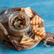Vegetarian Paté with toasted pieces of bread on a wooden cutting board