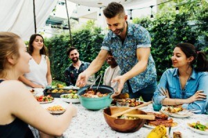 Friends at table with potluck food