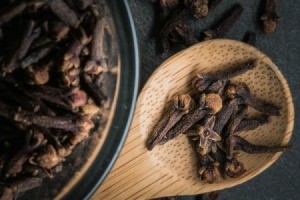 Cloves on a wooded spoon.