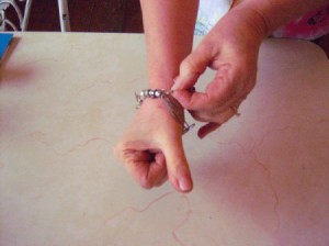 Hooking a bracelet closed by using a paper clip.