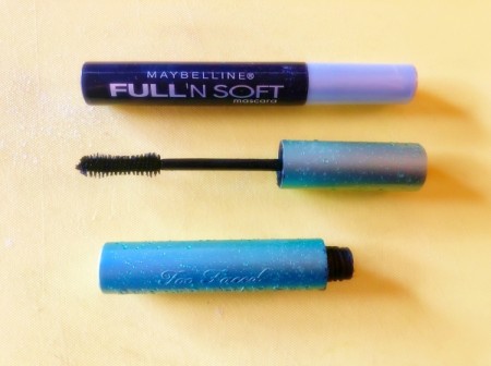 An expensive mascara wand next to a cheap mascara.