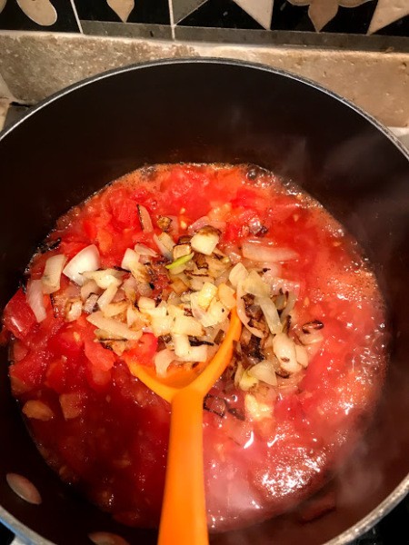 Spaghetti Sauce added to chopped onion in pan
