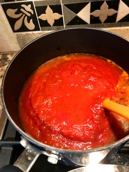 adding Spaghetti Sauce to tomatoes
