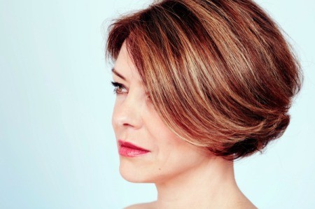 Woman with short highlighted hair.