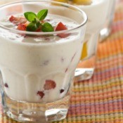 Glass full of Fruit pieces in a creamy liquid.