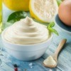 Homemade Mayonnaise with ingredients on a wooden table