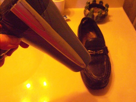 Leather shoes in the process of being polished with candle wax.