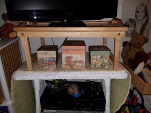 Raising a TV with a Modified Tray - view of tray with TV above and boxes below on table top